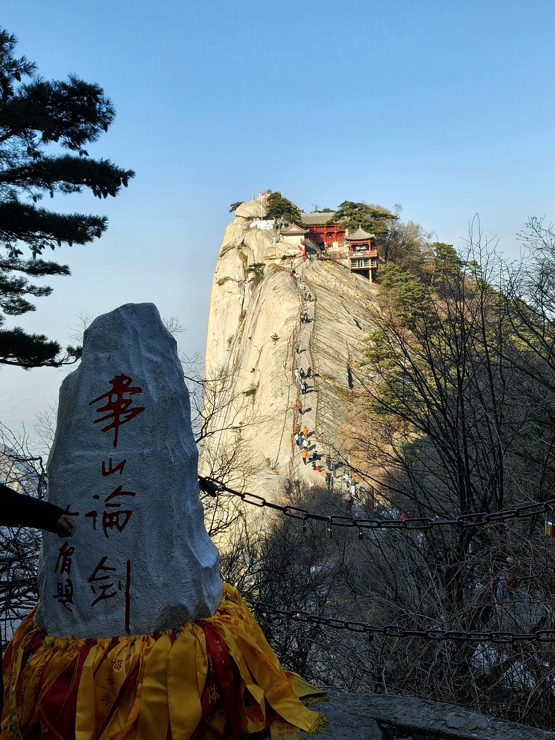 Temple perched on the cliff face of Hua Shan, with the stone marker for the Hua Shan Lun Jian viewpoint